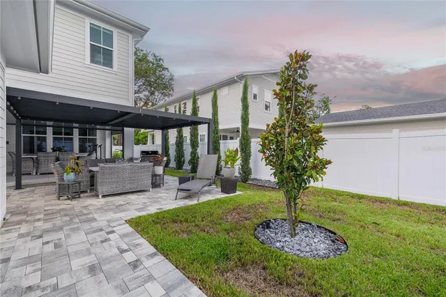 a front view of a house with garden and patio