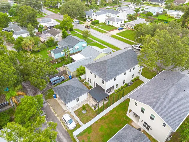 an aerial view of a house with a swimming pool and outdoor space