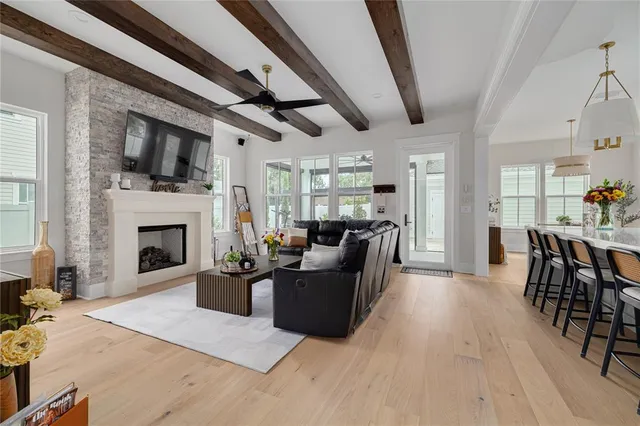a living room with furniture a fireplace and a flat screen tv