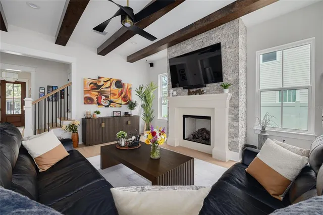 a living room with furniture fireplace and flat screen tv