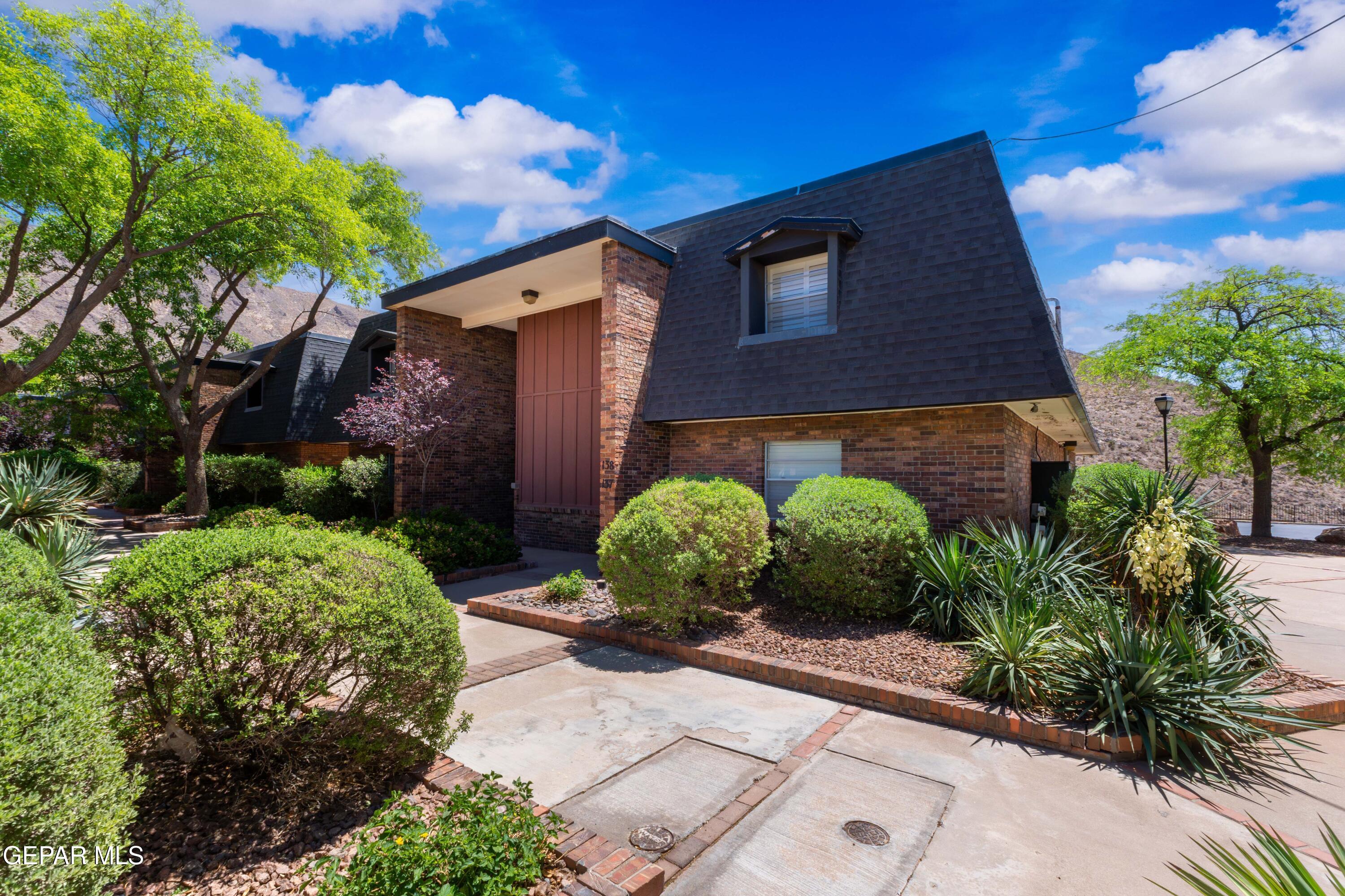 4800 North Stanton Street, Unit 137 El Paso, TX 79902 - Photo 1 of 28 a front view of a house with garden