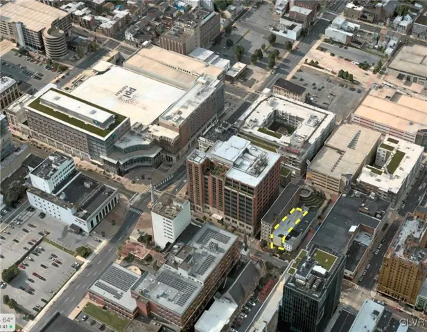 an aerial view of a building with parking