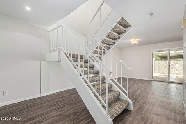 a view of entryway and hall with wooden floor