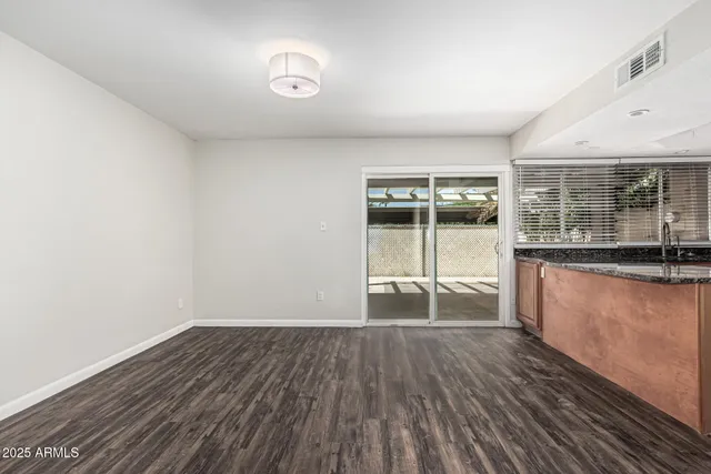 a view of a room with wooden floor and iron gate