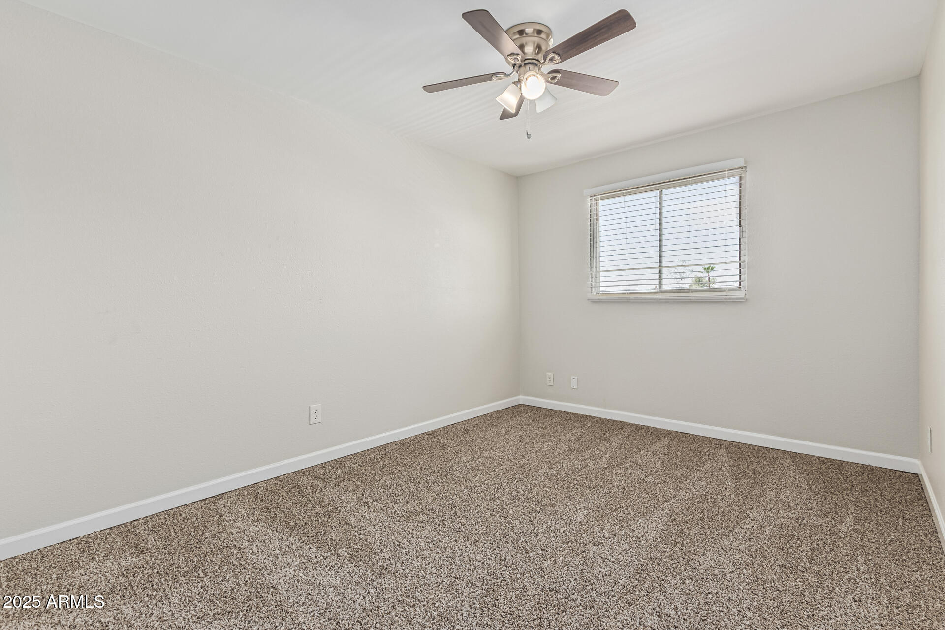 5815 East Thomas Road Scottsdale, AZ 85251 - Photo 8 of 19 an empty room with a window and a fan