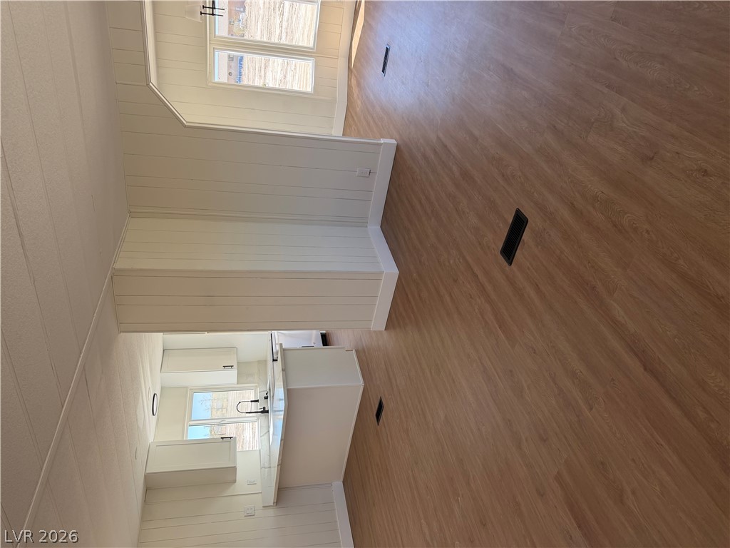 6401 Hafen Ranch Road Pahrump, NV 89061 - Photo 3 of 22 Warm wood flooring grounds the airy open layout connecting the main living spaces.