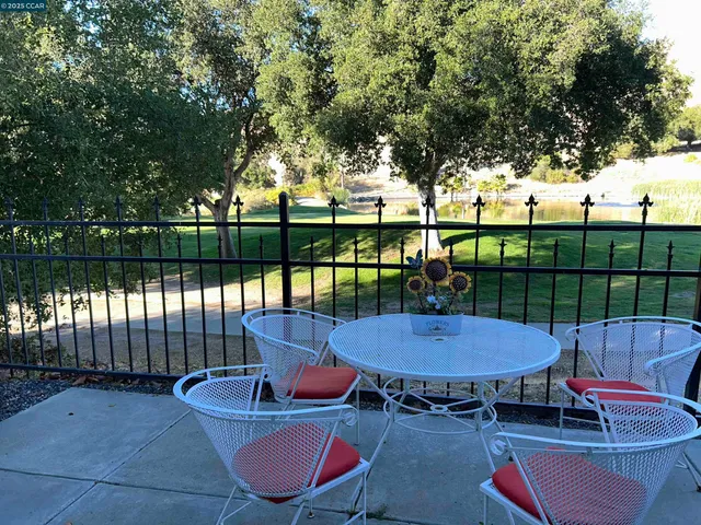 an outdoor sitting area with furniture and wooden floor