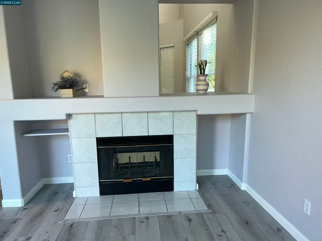 a room with fireplace and a wooden floor