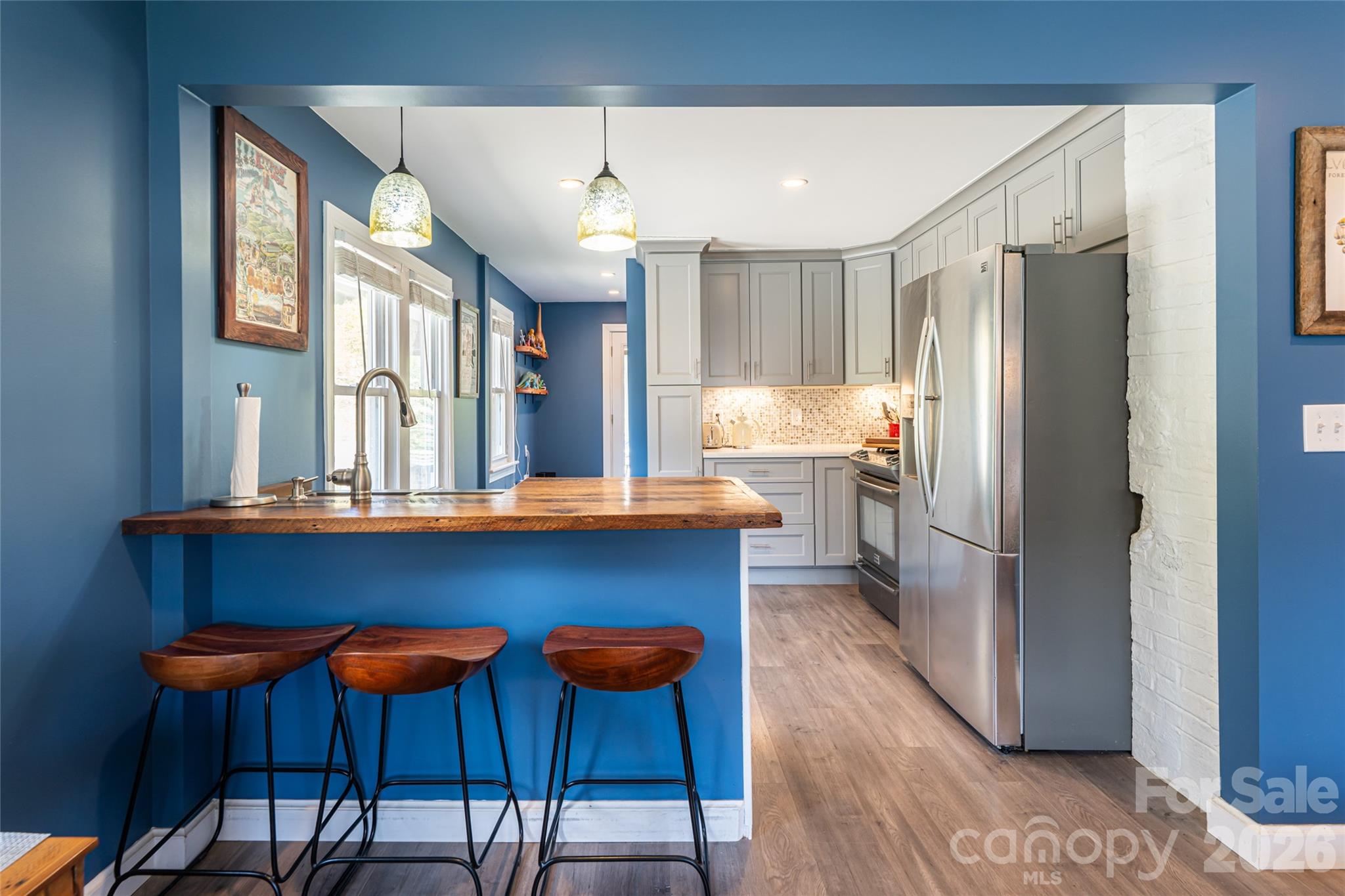 86 Rolling Hills Road Canton, NC 28716 - Photo 12 of 48 a kitchen with stainless steel appliances wooden floor and chairs