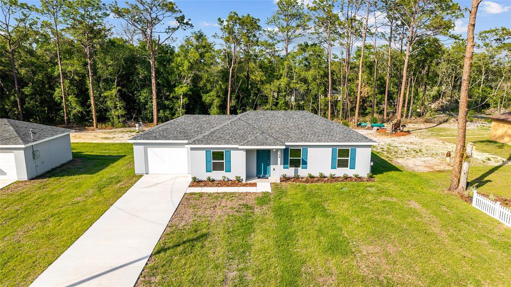 360 Locust Road Ocala, FL 34472 - Photo 1 of 48 a front view of house with yard and trees in the background