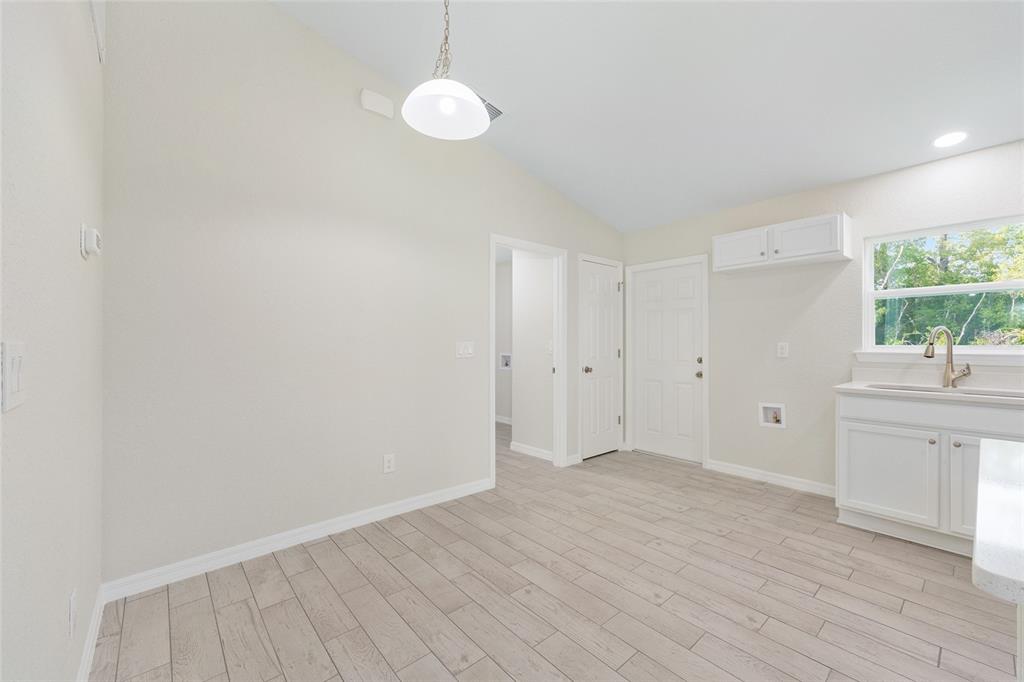 360 Locust Road Ocala, FL 34472 - Photo 16 of 48 wooden floor in an empty room with a window