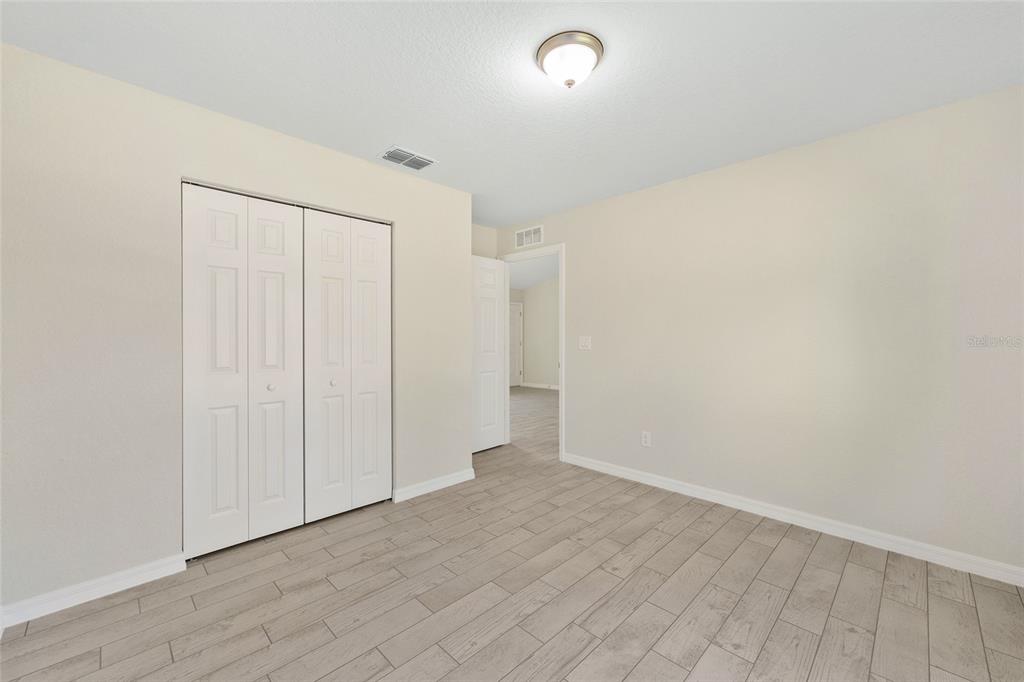 360 Locust Road Ocala, FL 34472 - Photo 30 of 48 an empty room with wooden floor and natural light