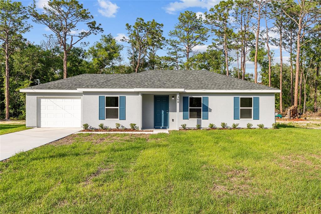 360 Locust Road Ocala, FL 34472 - Photo 3 of 48 front view of a house with a garden