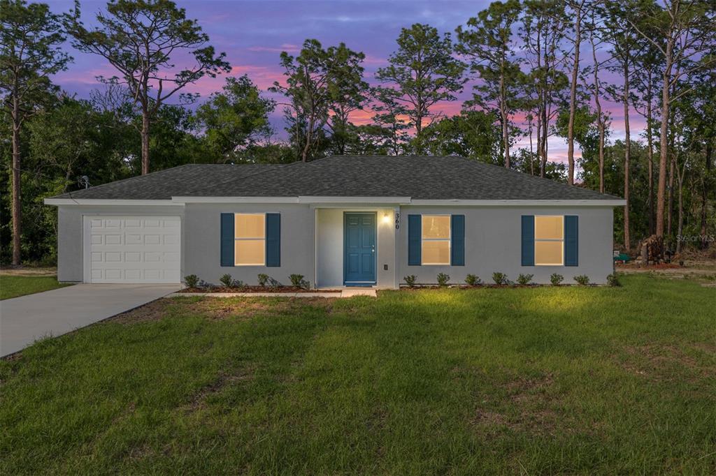 360 Locust Road Ocala, FL 34472 - Photo 4 of 48 front view of a house with a garden