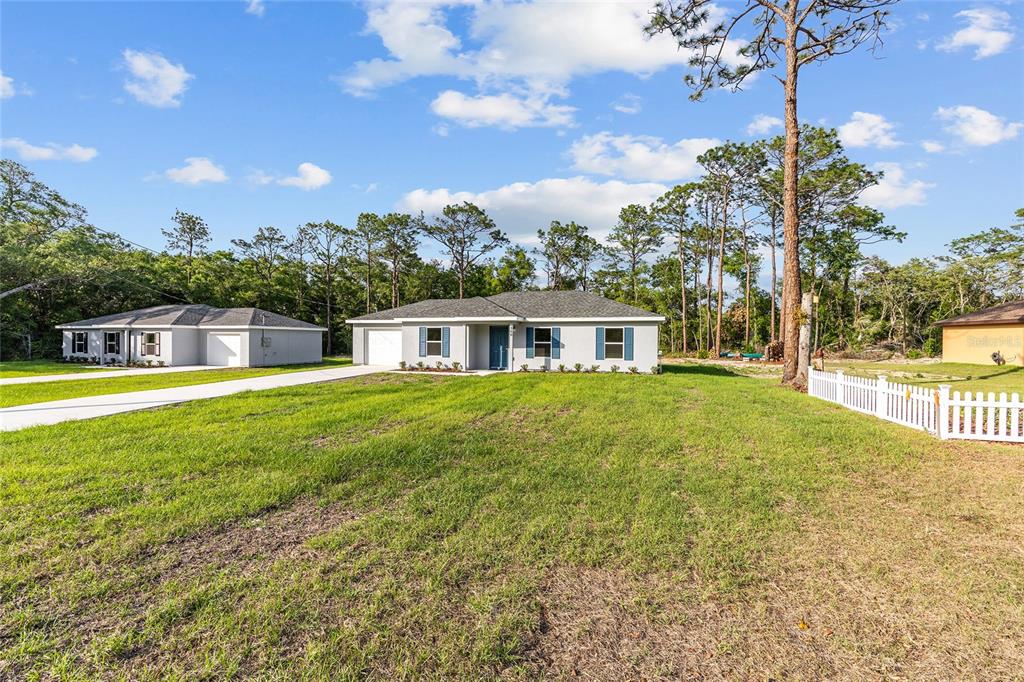 360 Locust Road Ocala, FL 34472 - Photo 6 of 48 a front view of a house with a yard
