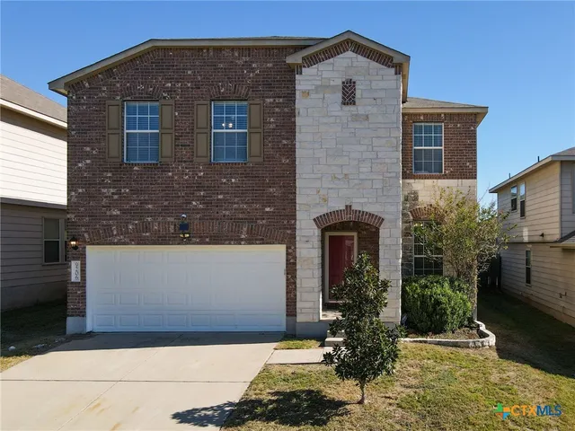 a front view of a house with yard
