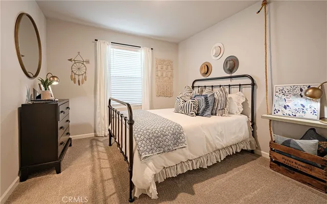 a bedroom with a bed and dresser with mirror