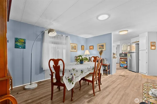 a dining room with furniture and wooden floor