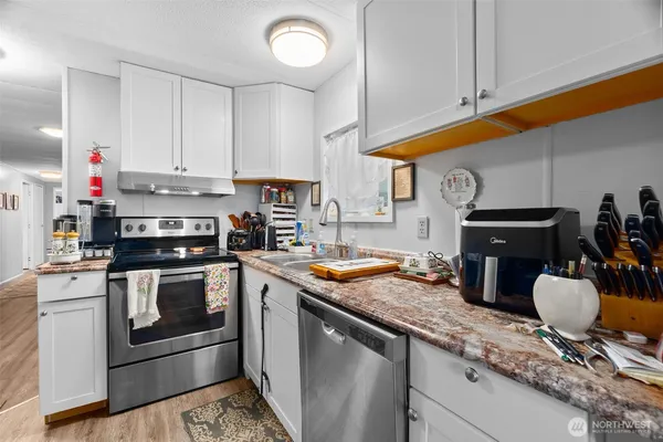 a kitchen with granite countertop stainless steel appliances and wooden cabinets