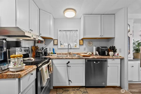 a kitchen with a sink a stove and cabinets