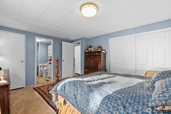 a bedroom with bed and a chandelier