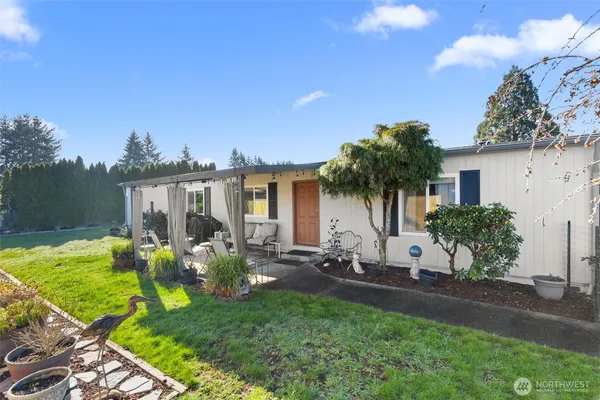 a front view of house with yard seating and green space