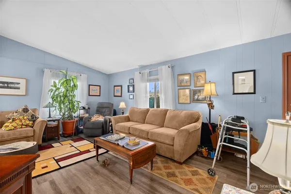 a living room with furniture rug and window