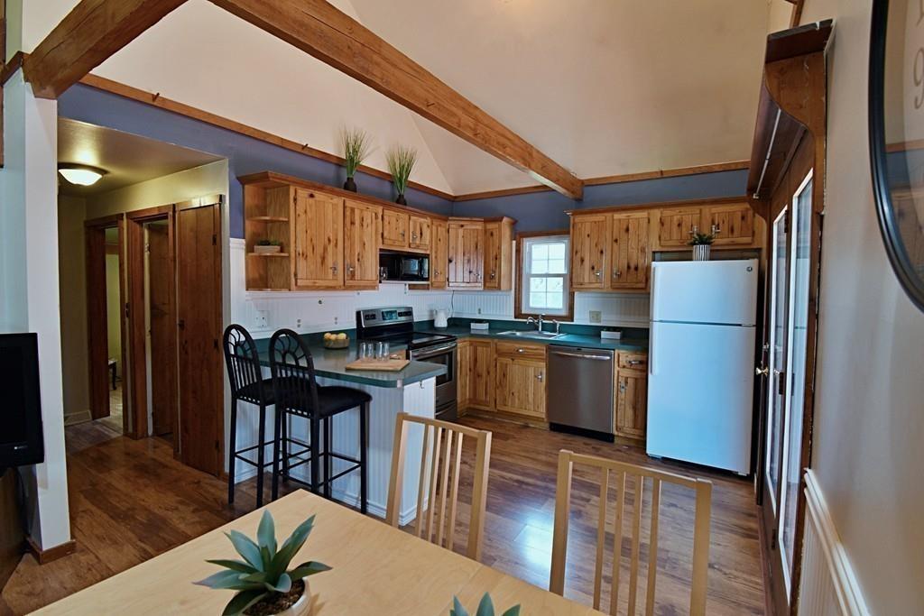 16 Emeline Road Weymouth, MA 02189 - Photo 13 of 40 a kitchen with stainless steel appliances granite countertop a refrigerator a stove a sink dishwasher and a dining table with wooden floor