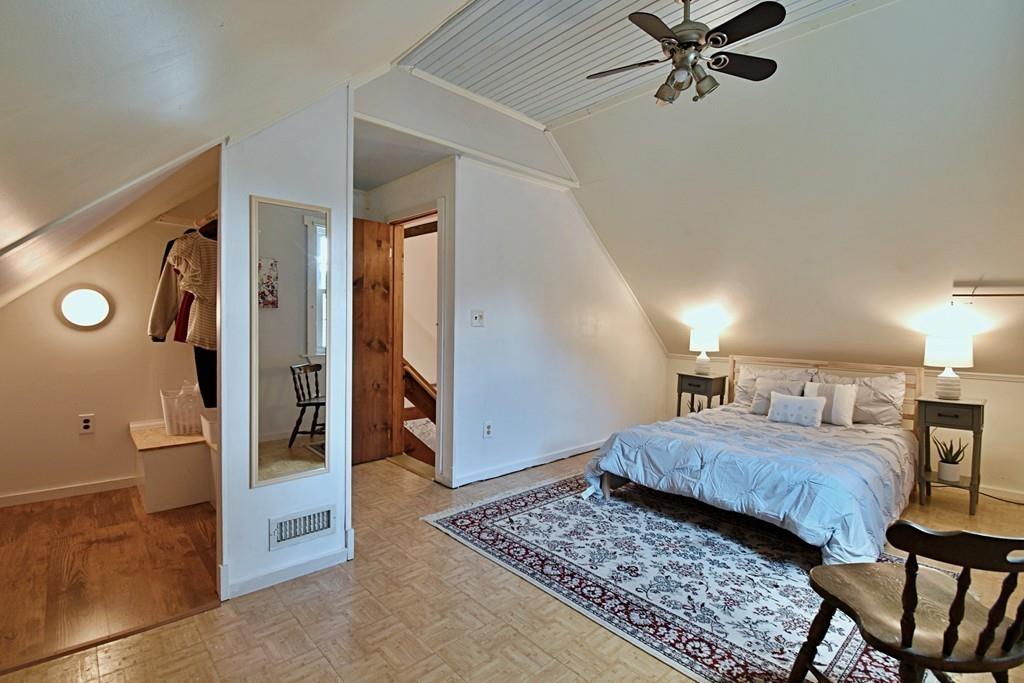 16 Emeline Road Weymouth, MA 02189 - Photo 23 of 40 a bedroom with a large bed and a chandelier