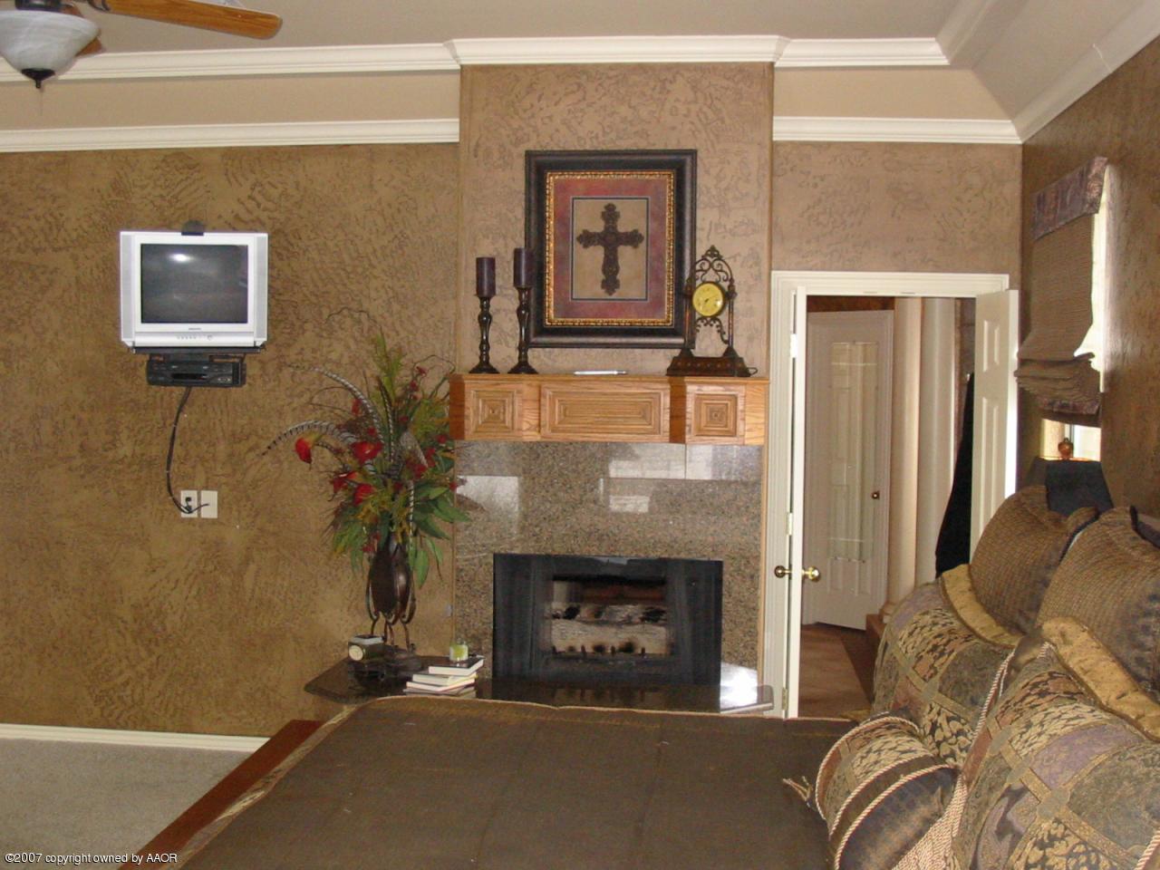 8900 Blackhawk Road Amarillo, TX 79119 - Photo 6 of 13 a living room with furniture and a fireplace