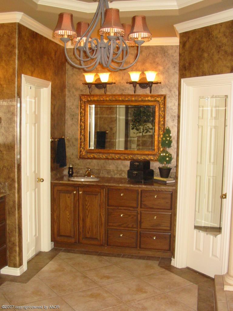 8900 Blackhawk Road Amarillo, TX 79119 - Photo 7 of 13 a bathroom with a sink and a mirror