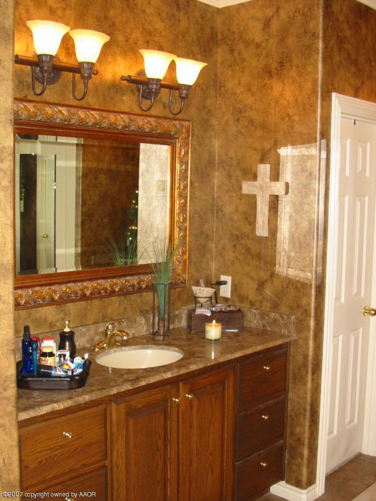 8900 Blackhawk Road Amarillo, TX 79119 - Photo 8 of 13 a bathroom with a sink and a mirror