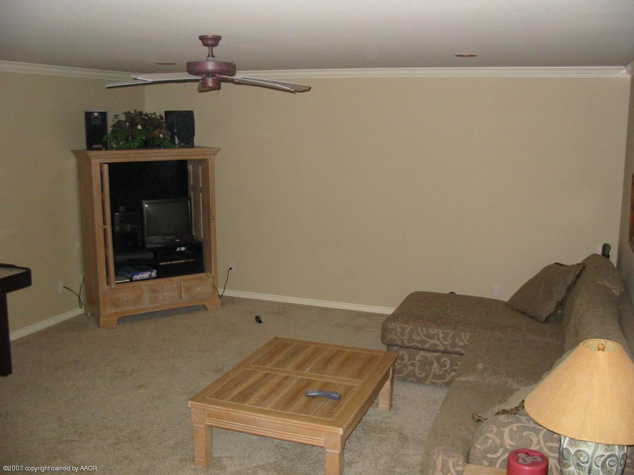 8900 Blackhawk Road Amarillo, TX 79119 - Photo 10 of 13 a living room with furniture and a fireplace