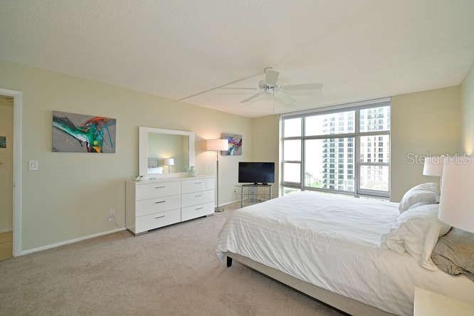 2425 Gulf Of Mexico Drive, Unit 7F Longboat Key, FL 34228 - Photo 13 of 50 a spacious bedroom with a bed and a window