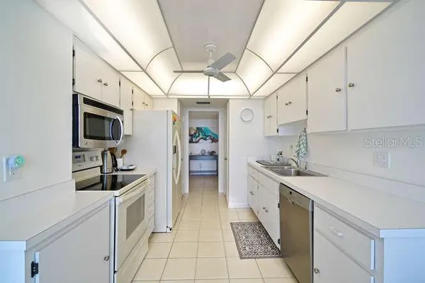 a kitchen with granite countertop a sink and cabinets