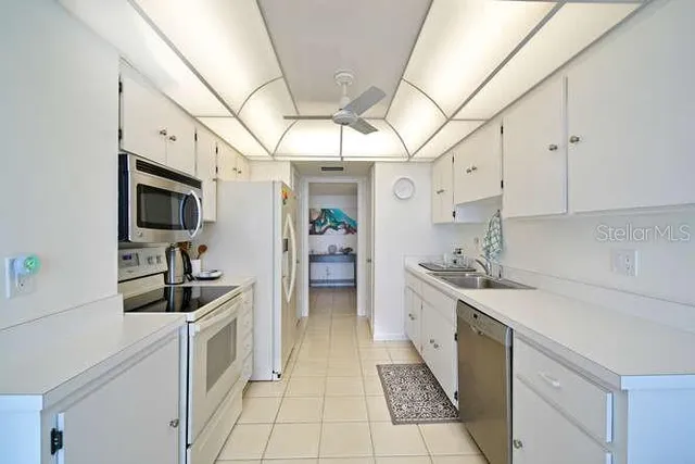 a kitchen with granite countertop a sink and cabinets