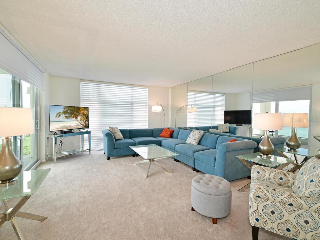 2425 Gulf Of Mexico Drive, Unit 7F Longboat Key, FL 34228 - Photo 22 of 50 a living room with furniture and a flat screen tv
