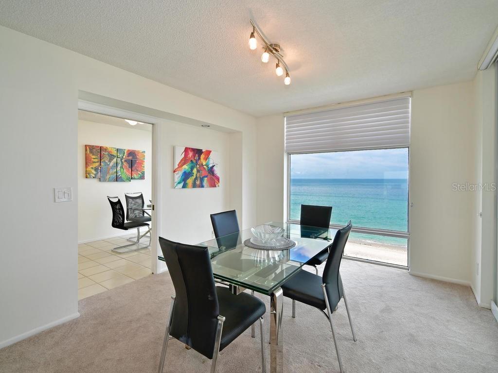 2425 Gulf Of Mexico Drive, Unit 7F Longboat Key, FL 34228 - Photo 23 of 50 a dining room with furniture and window