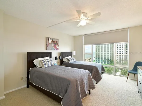 a spacious bedroom with a bed and a large window