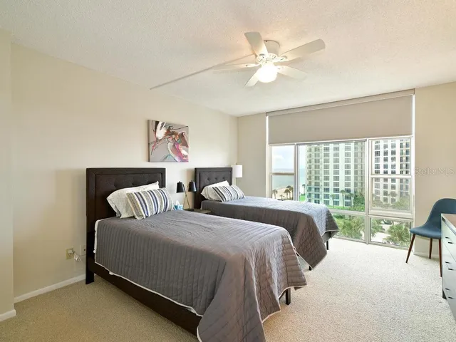 a spacious bedroom with a bed and a large window