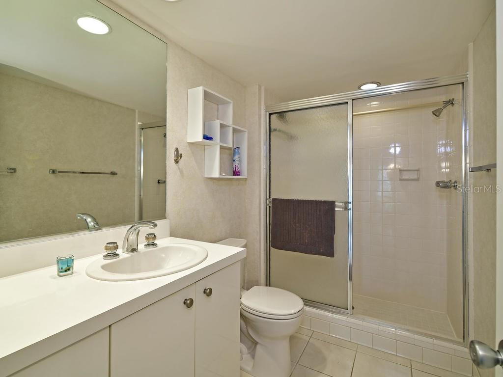 2425 Gulf Of Mexico Drive, Unit 7F Longboat Key, FL 34228 - Photo 34 of 50 a bathroom with a sink toilet and shower