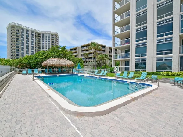 a swimming pool with outdoor seating and yard
