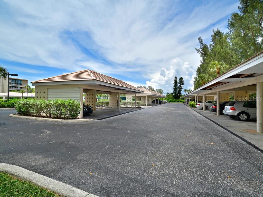 2425 Gulf Of Mexico Drive, Unit 7F Longboat Key, FL 34228 - Photo 49 of 50 a car parked in front of a building