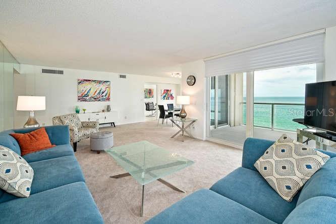 2425 Gulf Of Mexico Drive, Unit 7F Longboat Key, FL 34228 - Photo 8 of 50 a living room with furniture and a flat screen tv