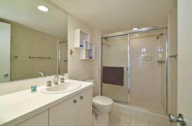2425 Gulf Of Mexico Drive, Unit 7F Longboat Key, FL 34228 - Photo 10 of 50 a bathroom with a sink toilet and shower