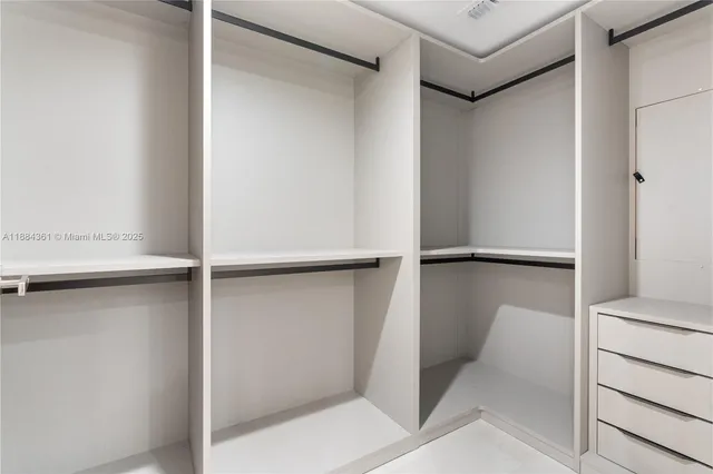 a bedroom with a bed tv and a window