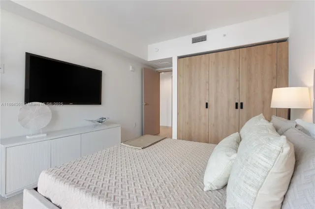 a bedroom with a bed and a cabinets