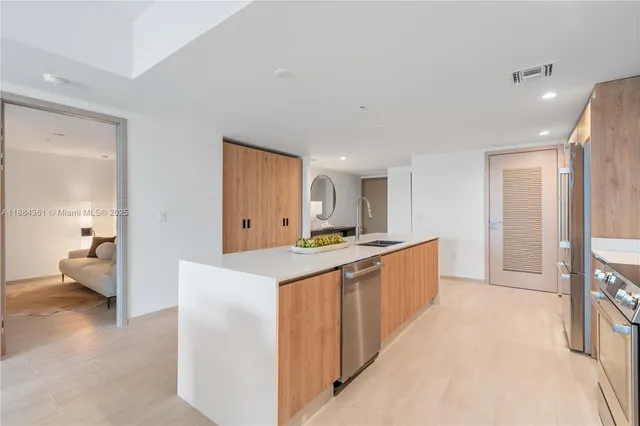 a kitchen with stainless steel appliances a sink stove and cabinets