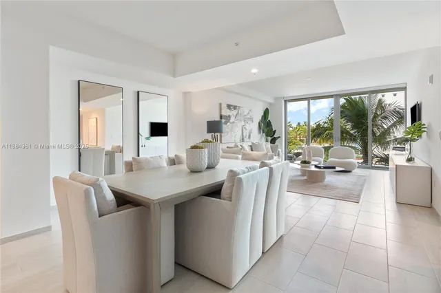 a living room with furniture a dining table and chairs