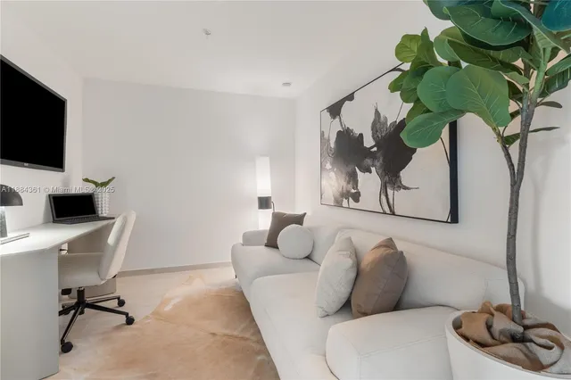 a living room with a balcony furniture and a large window